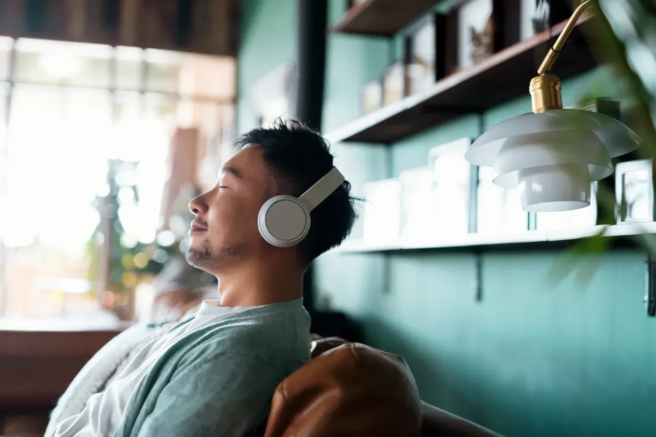 Person enjoying music on headphones indoors